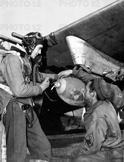 An American pilot examines a 5OO pound bomb (9th U.S Air Force January 1945)