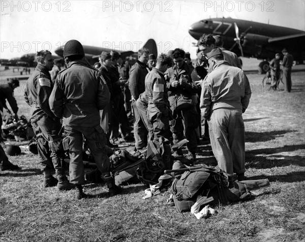 Parachutistes américains en conversation avant de s'envoler pour une mission à l'est du Rhin (24 mars 1945)