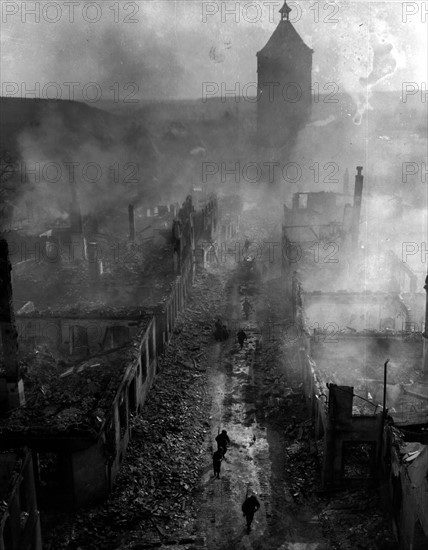 U.S soldiers move down a bomb-blasted  street of Waldenburg (Germany) April 16, 1945