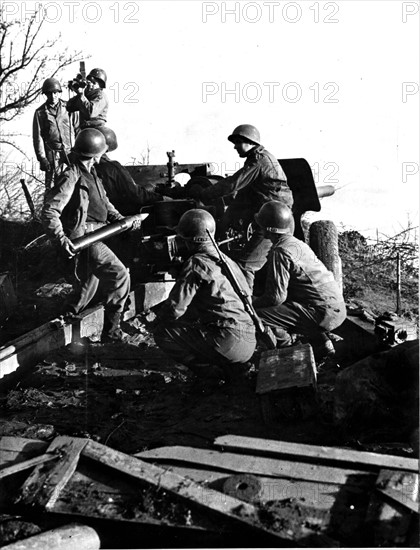 U.S tank destroyer unit  fires while Army Photographers film the action near Dillinger (Fall 1944)