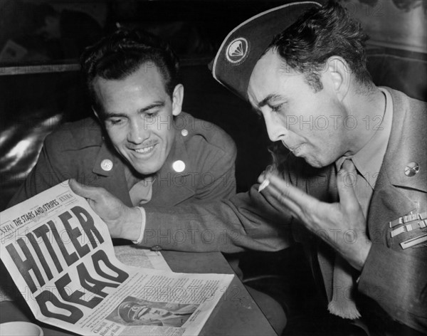 U.S.  soldiers read the Death of Hitler in Stars and Stripes Newspapers in Paris, May 2, 1944