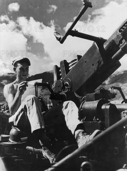 An American soldier reads a letter on the Salween River front, 1944