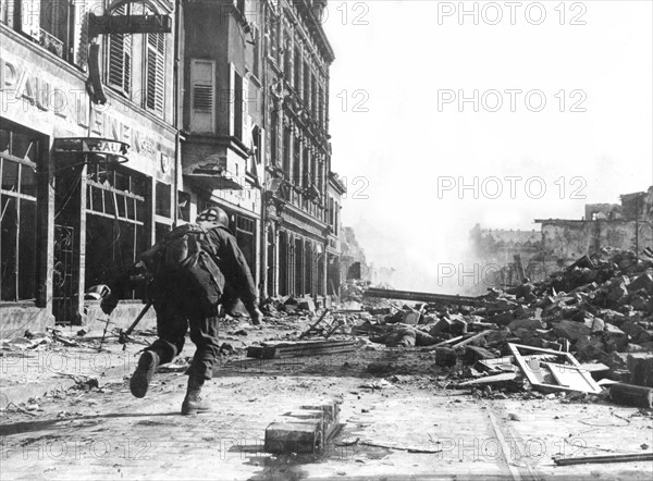 Medical corpsman rescues a wounded U.S. soldier in Saarlautern, March 3, 1945