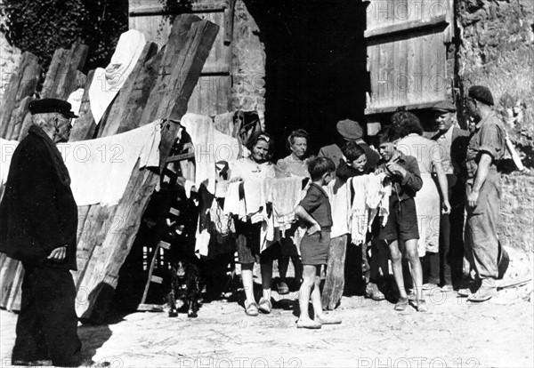 A  French soldier chats with residents of Ecouche, August 1944