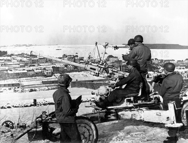 American soldiers man a 40mm. anti-aircraft gun in Wiltz, January 22, 1945