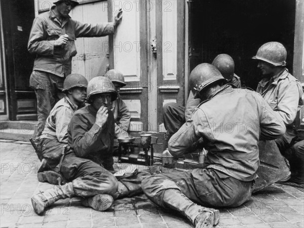 Quick meal in Cherbourg for U.S. troops, June 28, 1944