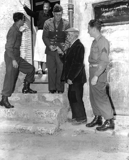 American soldiers off duty give some cigarettes to civilians in Nice, May 5, 1945