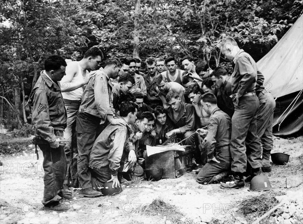 Officers and soldiers of the US Army reading the goals which were set for D-Day