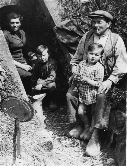 A French family has taken refuge in a drainage canal, to escape the bombings (1944)