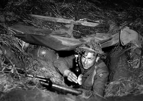 Belgian soldier with beer bottle at allied fall maneuver in Germany