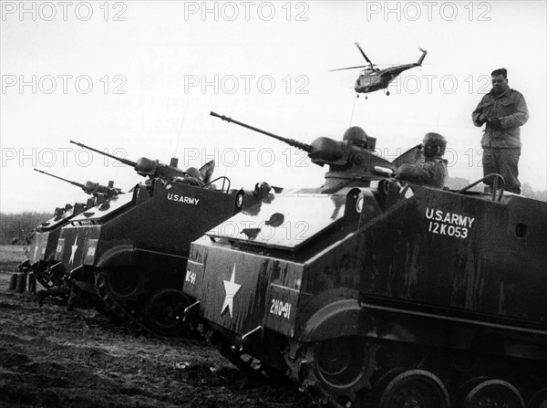 Armoured tracked vehicle and helicopter at manoeuvre of US army in Berlin Grunewald