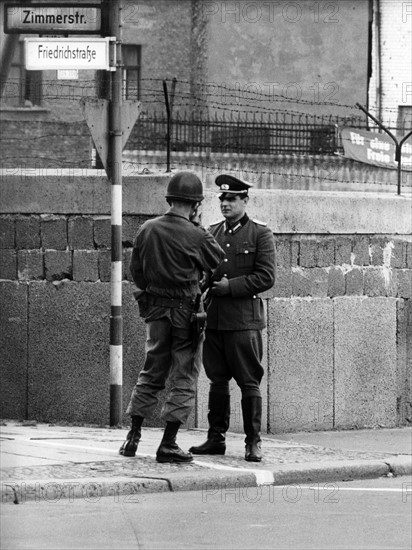 US soldier and People's Police officer standing face to face