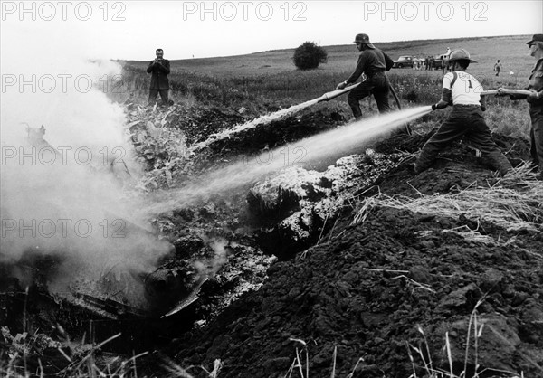 US fire brigade extinguishes burning wreckage of crashed army aircraft