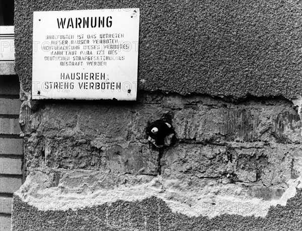 Warning sign at decrepit apartments of the US Army