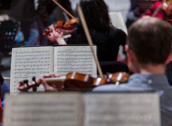 Musicians from the Syrian Expat Philharmonic Orchestra (SEPO) rehearse on 28 January 2016 in St. Nicholas' Church in Rostock (Mecklenburg-Western Pomerania). On 29 January 2016, the 64 musicians from 14 countries will perform Ludwig van Beethoven's Ninth Symphony at a charity concert. Some of the musicians fled the war in Syria, while others left their homes in Egypt or Palestine voluntarily to study music in Berlin or Munich. The donations collected during the evening will be used to finance projects with refugee children. Photo: Jens Büttner/dpa (for dpa "Orchestra with 64 musicians from 14 nations – concert for refugees" on 29 January 2016) | Worldwide use