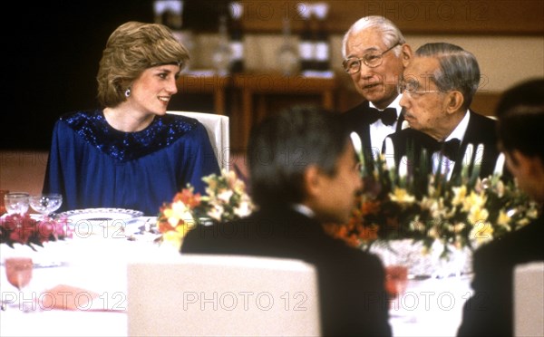 Diana, Princess Of Wales, at a dinner hosted By Emperor Hirohito in Japan. She is wearing a pleated royal blue evening dress designed by fashion designer Yuki and a sapphire and diamond headband made from jewels which she had reset from the Saudi Suite converting the watch into a choker to wear on her forehead. |