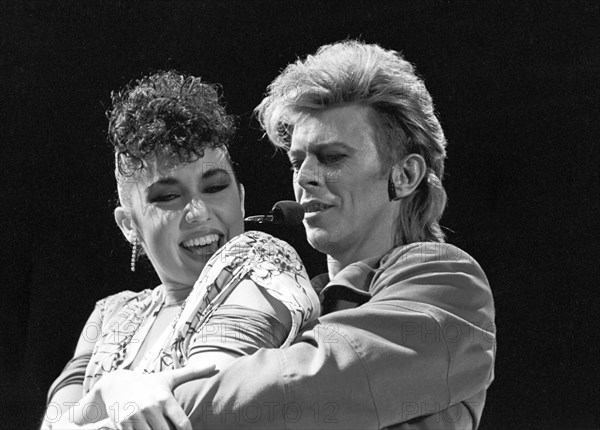 David Bowie (r) during his concert in West Berlin in front of the Reichstag building on the 6th of June in 1987