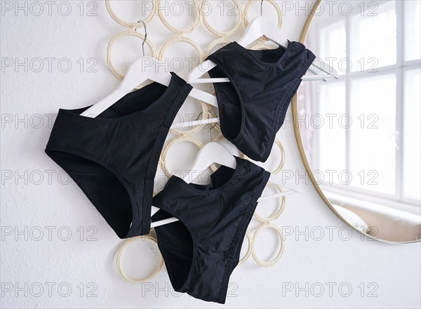 Period underwear hangs on hangers in a room. (posed scene) Period panties are increasingly conquering the market and, according to manufacturers, are supposed to be an environmentally friendly alternative to disposable products. (To dpa: "Sustainable period panties? Experts warn against biocides")