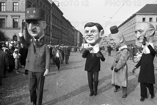 Seventy groups and wagons participate in the carnival parade of Munich on the 24th of February in 1963. The picture shows participants with oversized heads made of papier-maché, which depict amongst others Charles de Gaulle (l) and Konrad Adenauer (r).