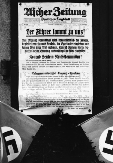 The image from the Nazi Propaganda! shows the newspaper of Asch of 2 October 1938 that announced the arrival of Adolf HItler in Asch on 3 October 1938, after the Munich Agreement of 29 September 1938. Photo: Fotoarchiv für Zeitgeschichte/Archiv || Mininum fee EUR 40