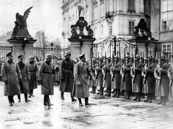 The image from the Nazi Propaganda! shows Adolf Hitler marching past an honorary company in the Castle District in Prague, Czech Republic, after the invasion of the so-called "Remainder of Czechia" by the German Wehrmacht , on 16 March 1939. From here, he announced the establishment of the "Protectorate of Bohemia and Moravia", which meant the dissolution of Czechoslovakia as a sovereign state. Photo: Fotoarchiv für Zeitgeschichte/Archiv || Mininum fee EUR 40