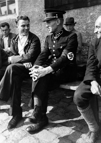 The Nazi propaganda picture shows Sudetenland refugees - including a Czechoslovakian police officer with swastika armband - in the refugee camp Selb, Germany, before the signing of the Munich Agreement, in September 1938. The original text from a Nazi news report on the back of the picture reads: "Pictures from the Sudetenland! Our picture was sent from the area of Asch and shows a former Czech police officer in the refugee camp in Selb. He was born in the Sudetenland and fled from Asch. He is now registered with the Freikorps." Photo: Fotoarchiv für Zeitgeschichte/Archive - NO WIRE SERVICE || Mininum fee EUR 40