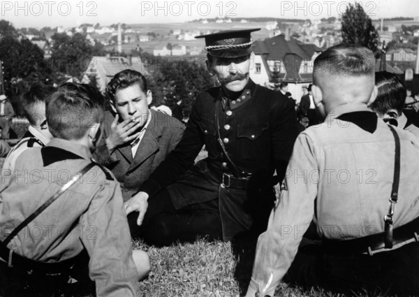 The Nazi propaganda picture shows a Sudetenland police officer who fled from Czechoslovakia speaking with Hitler youth in the run-up to the Munich Agreement in Baerenstein, Germany, September 1938. The original text from a Nazi news report on the back of the picture reads: " Sudeten Germans fleeing from Czech terror. This policeman fled from Weipert with other Sudeten Germans wearing a Czech police uniform tells his shocking experiences to these Hitler Youth (in Baerenstein). Photo: Fotoarchiv für Zeitgeschichte/Archive - NO WIRE SERVICE || Mininum fee EUR 40