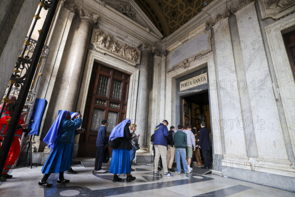 People enter the Basilica of Santa Maria Maggiore through the Holy Door.