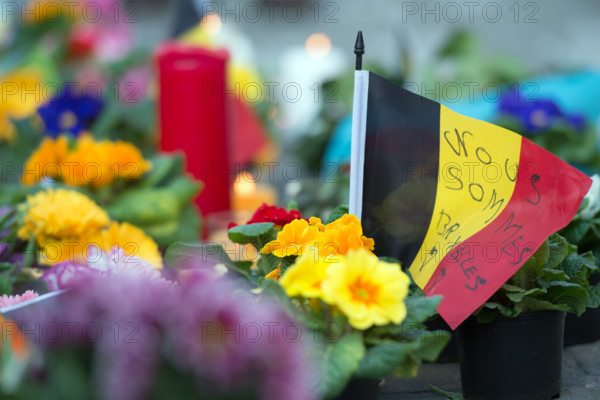 "Nous sommes Bruxelles" (We are Brussels) is written on a small belgian flag next to flowers and candles, outside the stock exchange at Place de la Bourse, in Brussels, Belgium, 22 March 2016. According to media reports, 34 people have been killed and around 230 injured in a series of terrorist attacks on 22 March 2016 in Brussels. PHOTO: FEDERICO GAMBARINI/DPA