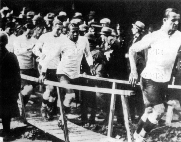 Uruguay's national football team with team captain Jose Nasazzi and Jose Leandro Andrade enters the pitch for the 1930 FIFA World Cup final against Argentina.
