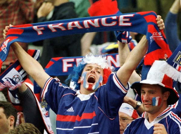 A French supporter holds up his fan scarf and frenetically cheers on his team during the World Cup semi-final game France against Croatia in Saint Denis, near Paris, France, 8 July 1998. France wins by a score of 2-1 and advances to the final against defending champion Brazil.
