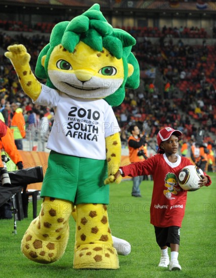 Zakumi, the official World Cup mascot walks hand in hand with a small girl on the pitch prior to the 2010 FIFA World Cup third place match at the Nelson Mandela Bay Stadium in Port Elizabeth, South Africa 10 July 2010. Photo: Marcus Brandt dpa - Please refer to http://dpaq.de/FIFA-WM2010-TC ++