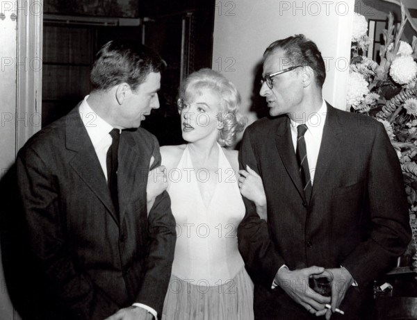A happy trio at the Monroe cocktail party left to right Yves Montand, Marilyn Monroe and her husband America's foremost playwright Arthur Miller.