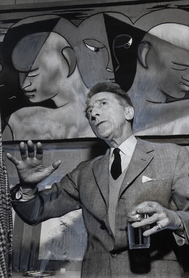 Cocteau standing by an Aubusson tapestry, made after one of his paintings (1955)