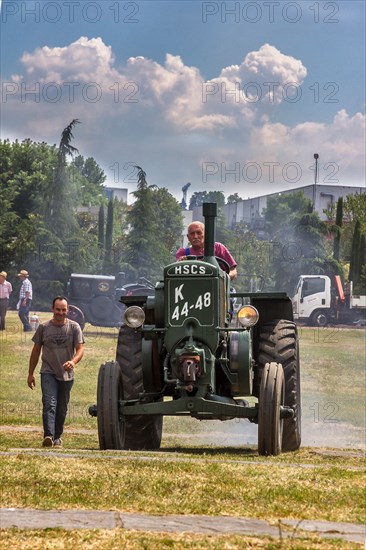 Old Tractor at a gathering of vintage vehicles.