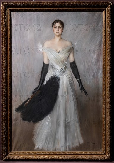 “Portrait of a lady in white with gloves and fan” by Giovanni Boldini