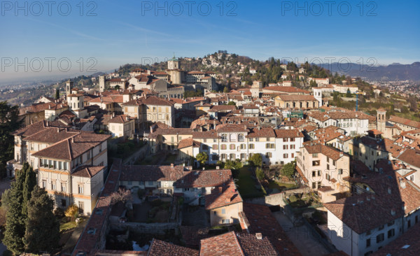 Bergamo, Città alta: veduta della città verso Ovest dalla Torre Civica, detta il Campanone. A sinistra, il Palazzo Vescovile con i suoi Giardini. Al centro, la Chiesa e il Seminario di Papa Giovanni XXIII. Sullo sfondo, il Colle e il Castello di San Vigilio (IX secolo). A destra, si intravvede la Val Brembana.

[ENG]
Bergamo, Città alta: view of the town toward West from the Civic Tower, known as the Campanone. On the left, the Episcopal Palace with its gardens. At the centre, the Church and the Seminary Pope John XXIII. In the background, the St. Vigilius Hill and Castle. On the right, the Brembana Valley.
Bergamo (BG), Lombardia - Lombardy, Italia - Italy