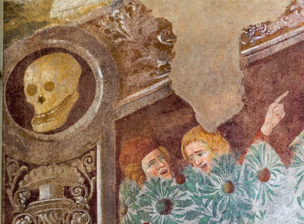 Clusone, Oratorio dei Disciplini o di San Bernardino, facciata: affreschi  "Trionfo della Morte" (parte alta) e "Danza Macabra" (parte bassa), 1485. Opera dell'artista clusonese Giacomo Borlone De Buschis.
Dettaglio del Trionfo della Morte: La Morte si trova sopra un sarcofago al cui interno si trovano ormai privi di vita il Papa e l’Imperatore con intorno serpenti, rospi e scorpioni (simboli di superbia e morte improvvisa). La Morte tiene in mando grossi cartigli che ricordano che  tutti sono destinati a lasciare il mondo terreno.

[ENG] 
Clusone, Oratory of Disciplini or St. Bernardino, façade: frescoes with the Triumph of Death on the top and a Dance of Death (Macabre Dance) in the lower register (1485). All the frescoes are by Giacomo Borlone De Buschis.
Detail of the Triumph of Death standing on a sarcophagus where the dead Pope and the Emperor lie. Theay are surrounded by serpents, scorpions and toads (symbols of pride and sudden death). Death hold big scrolls to remind ever...