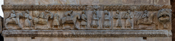 Fidenza, Duomo (Cathedral of San Donnino), right tower (Trabucco Tower), southern side: frieze composed of six panels with “The Procession of Charlemagne returning to France after having freed Rome from the Saracens”. This interpretation is supported by the panel depicting a knight holding the bridle of a horse with a cheetah on its back that the emperor used for hunting.
It has been interpreted in the past as the depiction of pilgrims on the road to Rome (to the point of becoming one of the symbolic icons of the Via Francigena).
Cattedrale di San Donnino, Fidenza (PR), Emilia-Romagna, Italia - Italy