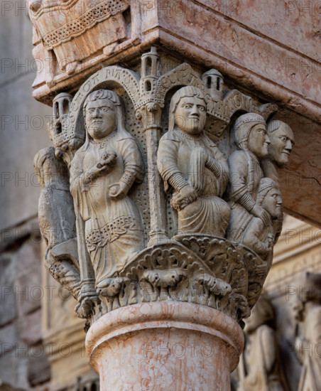 Fidenza, Duomo (Cattedrale di San Donnino), facciata, portale maggiore, protiro: il capitello di sinistra con “Storie di Maria Vergine”.
 La Madonna è raffigurata nella parte frontale del capitello sotto un edificio sostenuto da due colonne, a figura intera, incinta, ha la rosa in mano; sull’archetto vi è l’iscrizione SCA. MA RIA (Sancta Maria = Santa Maria); a destra, Elisabetta è seduta su uno sgabello con un panno in mano; sull’archetto soprastante vi è l’iscrizione ELIZA.BET (Elisabeth = Elisabetta).
Opera di Benedetto Antelami e bottega.

[ENG]
Fidenza, Duomo (Cathedral of San Donnino), facade, main portal, prothyrum: the left capital with “Stories of the Virgin Mary”.  The Madonna is depicted on the front of the capital under a building supported by two columns, full-figure, pregnant, with a rose in her hand; on the arch is the inscription SCA. MA RIA (Sancta Maria = Holy Mary); on the right, Elizabeth is seated on a stool with a cloth in her hand; on the arch above is the i...