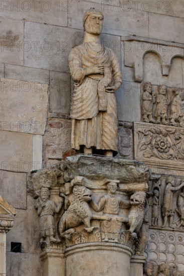 Fidenza, duomo (Cattedrale di San Donnino), sculture tra il portale maggiore e quello di sinistra: 
il capitello con “Daniele nella fossa dei leoni”, sormontato dalla statua con “San Simone Apostolo che mostra la via di Roma ai pellegrini”;
Cattedrale di San Donnino, Fidenza (PR), Emilia-Romagna, Italia - Italy