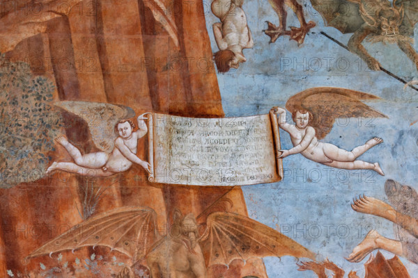 Pisa, Camposanto monumentale: ”Trionfo della Morte”, particolare degli affreschi di Buonamico Buffalmacco, 1336/1341. Dettaglio  con il cartiglio retto da due Geni alati che riporta la lezione che deve trarsi dalla visione dell’insieme: «Schermo di sapere e di ricchezza / di nobiltade e ancora di prodezza / val neente a’ colpi di costei. / Et ancor non si trova contro lei / o lettere veruno argomento. / E non avere l’intelletto spento / di stare sempre sì apparecchiato, / che non ti giunga in peccato mortale».


[ENG]
Pisa, Monumental Cemetery: "Triumph of Death," detail of the frescoes by Buonamico Buffalmacco, 1336/1341.Detail with the cartouche held by two winged Genies which reports the lesson to be learned from the overall view: «A shield of knowledge and wealth / of nobility and even of prowess / is worth nothing against her blows. / And yet no argument can be found against her / or letters. / And do not have your intellect dulled / from always being so prepared, / that you d...