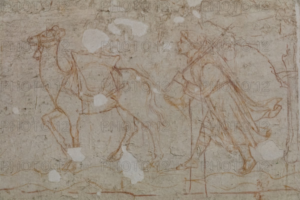 Pisa, Museo delle sinopie: “Tebaide”,
storie degli Eremiti e dei Santi Padri ispirate alla “Vitae Patrum” del canonico domenicano Cavalca. Sinopia preparatoria agli affreschi del Camposanto di Buonamico Buffalmacco, 1336/1341. Particolare di un monaco che si avvicina alla porta della città con un cammello carico. 

[ENG]
Pisa, Sinopia Museum: “Thebaid”, Stories of the Hermits and the Holy Fathers inspired by the Vitae Patrum by the Dominican Domenico Canon Cavalca. Sinopia preparatory to the frescoes by Buonamico Buffalmacco, 1336/1341. 
Detail of a monk approaching the city gate with a loaded camel.
Museo delle sinopie, Pisa (PI), Toscana - Tuscany, Italia - Italy