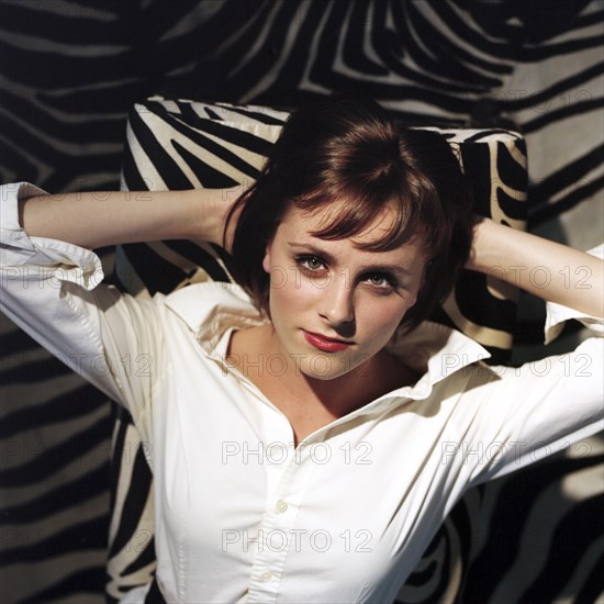 Woman Relaxing on Zebra Print Chair