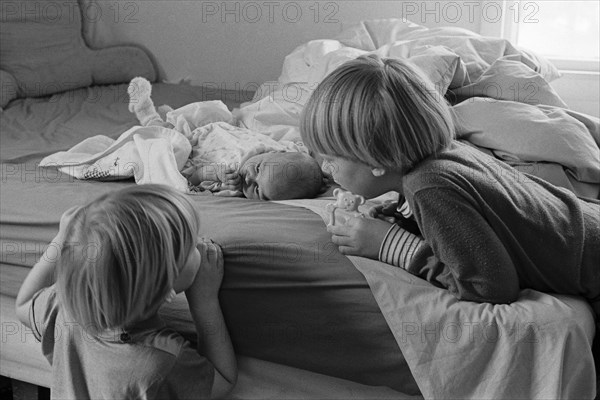 Young Boys Looking at Newborn Baby,