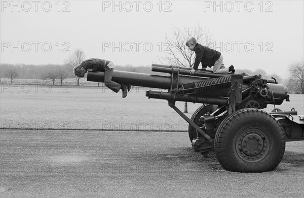 Two Boys Playing on Old Cannon