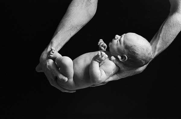 Father Holding Newborn Baby