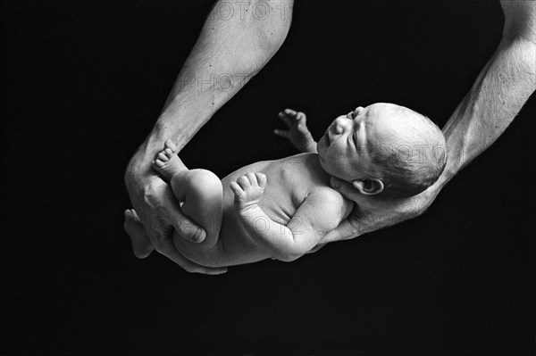 Father Holding Newborn Baby