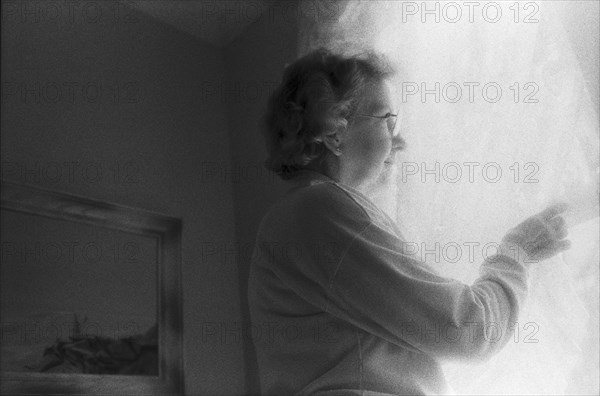 Elderly Woman Looking Out Window