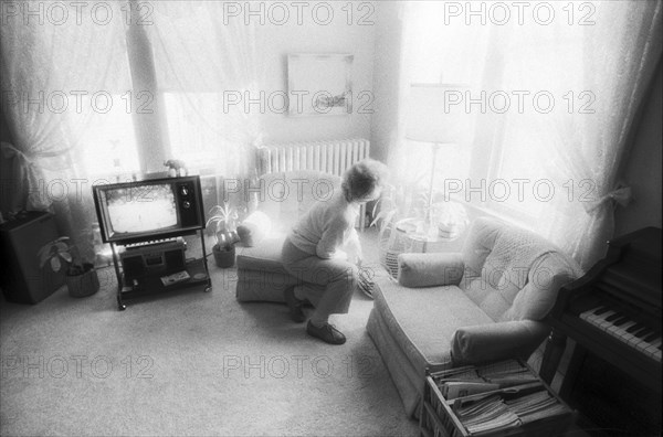 Elderly Woman Looking Out Window